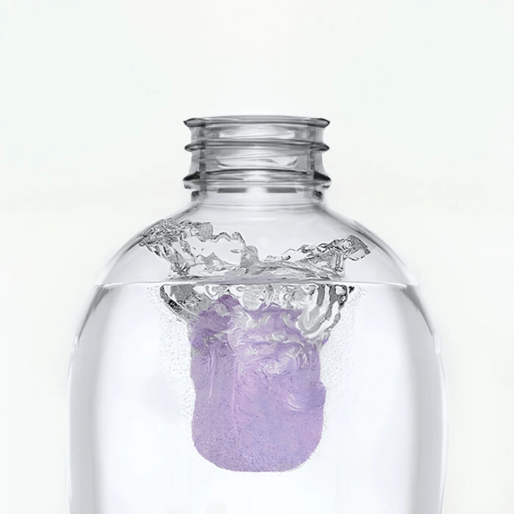 Macro close-up photo showing a purple NuroClean tablet dissolving inside water at the bottom of the clear spray bottle