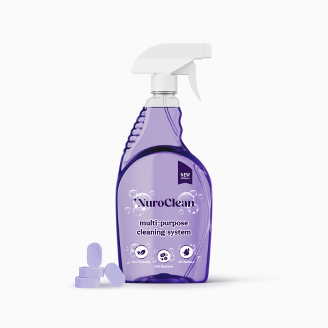 Studio visual of the NuroClean reusable clear spray bottle with purple trigger alongside loose purple dissolving cleaning tablets